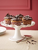 Several chocolate cupcakes on cake stand