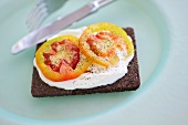 Quark and tomato on a slice of pumpernickel