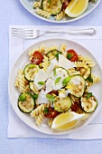 Pasta salad with courgettes, tomatoes, herbs and Parmesan