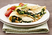 Pancakes filled with spinach, mozzarella and pine nuts