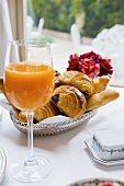 A glass of multivitamin juice and breakfast pastries