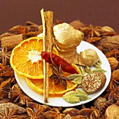 Christmas spices and dried orange slices on plate