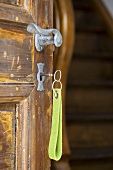 Key in the lock of a rustic house door
