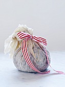 Christmas pudding in a cloth tied with a bow