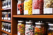 Various sweets in jars on shelves