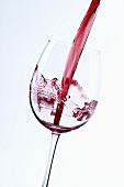 Pouring red wine into glass