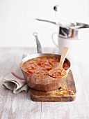 Tomato sauce in pan, food mill