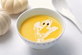 Cream of pumpkin soup with a cream ghost