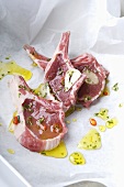 Raw pork chops with olive oil, garlic and herbs