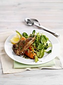 Lamb chop with carrots and salad leaves