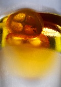 Orange liqueur in glass with condensation (close-up)