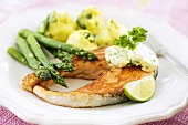 Salmon steak with herb butter and green asparagus