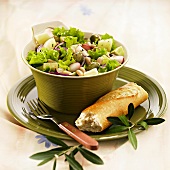 Vegetable salad with radishes, olives & pineapple, baguette