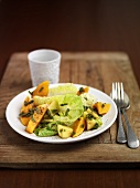 Salad leaves with sweet potatoes and mango