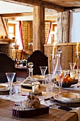 Laid table with fine glasses in an Alpine chalet