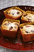 Small cherry and almond cakes with icing sugar