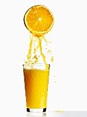 Orange juice with half an orange