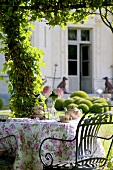 Romantic tea table in garden, Château de la Verrerie, France