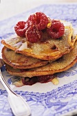 Pancakes with maple syrup and raspberries