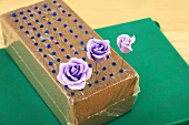 Purple sugar roses in a block of foam