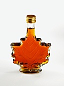 A bottle of maple syrup in the shape of a maple leaf