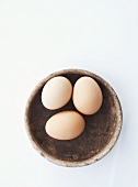 Three eggs in bowl from above