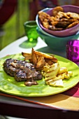 Jamaican steaks with potato wedges and pineapple