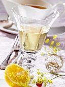 Glass of white wine on table laid for special occasion