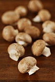Chestnut mushrooms on wooden background