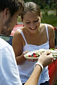 Young couple eating panna cotta with berries