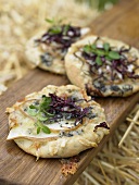 Pizzette topped with pear, radicchio and Gorgonzola