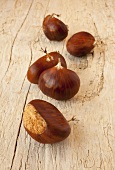 Several chestnuts on wooden background