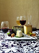 Cheese platter with fruit, nuts and wine