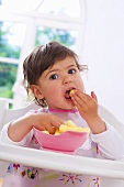 Little girl eating corn puffs