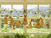 Iced Easter Bunnies hanging in front of window