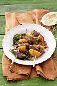 Lamb kebabs with sesame seeds and spinach