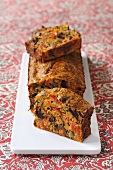 Vegetable loaf with olives, tomatoes and anchovies, partly sliced