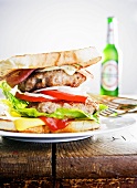 Cheeseburger and bottle of beer