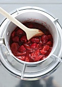 Making berry sauce (warming berries in bain-marie)