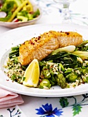Grilled salmon on rice, green asparagus, spring onions