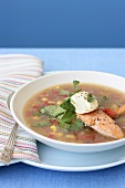 Vegetable soup with fish and fresh coriander