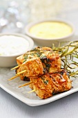 Chicken skewers with rosemary and sauces