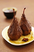Two chocolate-coated pears