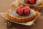 Chocolate tarts with raspberries