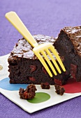 Brownie with pieces of red pepper on napkin