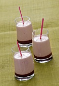 Three strawberry milkshakes