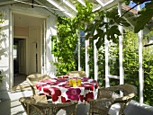 Table with glasses of orange juice, wicker chairs in conservatory