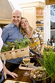 Couple with herbs and red cabbage in kitchen