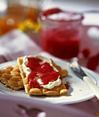 Quark cream and raspberry buttermilk spread on crispbread