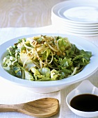 Green salad with Asian noodles, peanuts and chilli